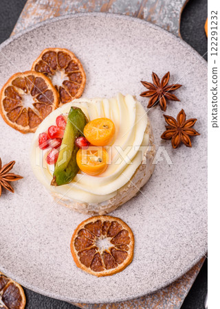 Piece of sweet meringue with citrus, kiwi and pomegranate seeds 122291232