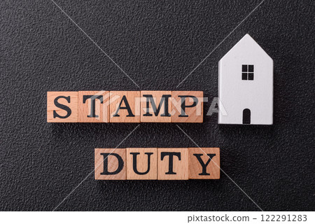 The inscription Stamp Duty made of wooden cubes on a plain background The inscription Stamp Duty made of wooden cubes on a plain background 122291283