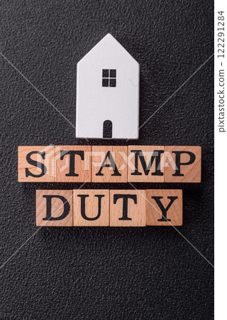 The inscription Stamp Duty made of wooden cubes on a plain background 122291284