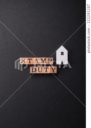 The inscription Stamp Duty made of wooden cubes on a plain background The inscription Stamp Duty made of wooden cubes on a plain background 122291287