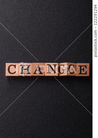 The inscription chance or change with wooden cubes on a dark concrete background The inscription chance or change with wooden cubes on a dark concrete background 122291294