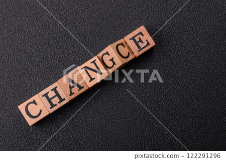 The inscription chance or change with wooden cubes on a dark concrete background The inscription chance or change with wooden cubes on a dark concrete background 122291296