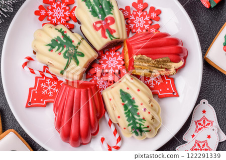 Sweet Madeleines desserts covered with chocolate in Christmas colors Sweet Madeleines desserts covered with chocolate in Christmas colors 122291339