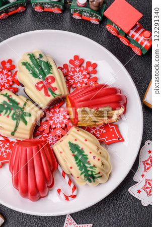 Sweet Madeleines desserts covered with chocolate in Christmas colors Sweet Madeleines desserts covered with chocolate in Christmas colors 122291340