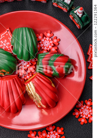 Sweet Madeleines desserts covered with chocolate in Christmas colors Sweet Madeleines desserts covered with chocolate in Christmas colors 122291364