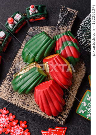Sweet Madeleines desserts covered with chocolate in Christmas colors Sweet Madeleines desserts covered with chocolate in Christmas colors 122291372