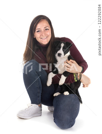 puppy border collie and woman in studio 122292884