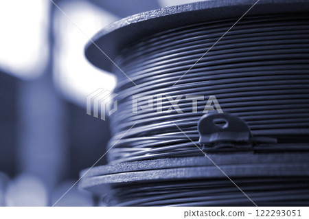 Spool of plastic filament for 3D printing. Spools of filament for melting in process of FDM 3D printing. 3D Printing FDM technology. Modern 3d printing technologies. Additive progressive technologies 122293051