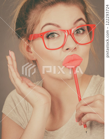 Happy woman holding fake lips on stick 122293724