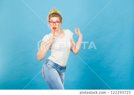 Happy woman holding fake lips on stick Happy woman holding fake lips on stick 122293725