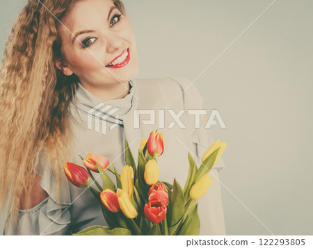 Pretty woman with red yellow tulips bunch 122293805