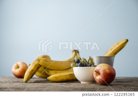 Fresh fruit medley on a wooden rustic table Fresh fruit medley on a wooden rustic table 122295165