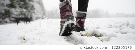 Female legs in winter boots walking in snow covered nature Female legs in winter boots walking in snow covered nature 122295176