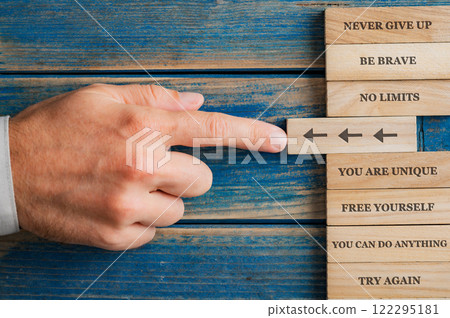 Stacking wooden pegs, each with a unique positive and motivational quote about success and personal development Stacking wooden pegs, each with a unique positive and motivational quote about success and personal development 122295181