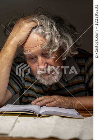 Elderly man deep in his thoughts 122295233