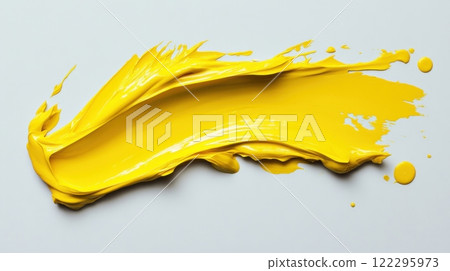 Vibrant yellow paint stroke on white background capturing artistic creativity 122295973