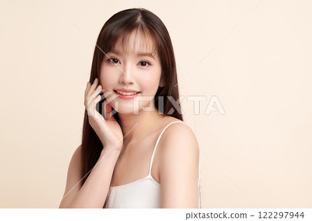 Beautiful young asian woman with clean fresh skin on beige background, Face care, Facial treatment, Cosmetology, beauty and spa, Asian women portrait. 122297944