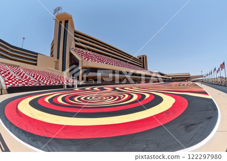 Vibrant racetrack design at a motorsport venue in the afternoon sunlight showcasing a unique spiral pattern 122297980