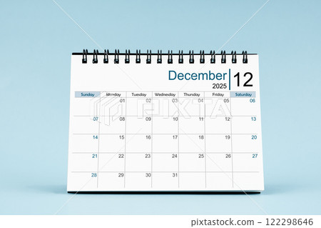 December 2025 Monthly desk calendar for 2025 year on soft blue background. December 2025 Monthly desk calendar for 2025 year on soft blue background. 122298646