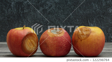 Three rotten apples with mold on a dark background Three rotten apples with mold on a dark background 122298764