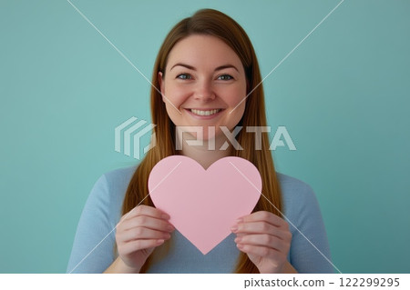 Hands holding blank heart-shaped card Hands holding blank heart-shaped card 122299295