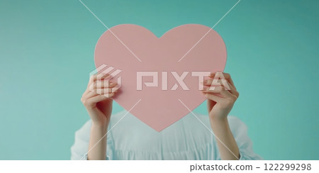 Heart paper held by hands in front of blue Heart paper held by hands in front of blue 122299298
