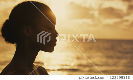 Woman Practicing Yoga by Ocean Waves Woman Practicing Yoga by Ocean Waves 122299518