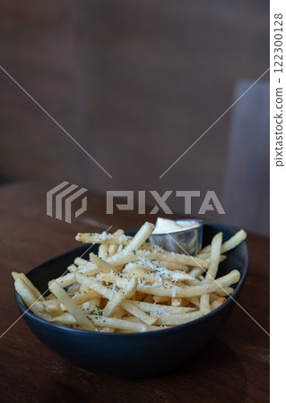 Close up of French Fries with cheese in a cup 122300128