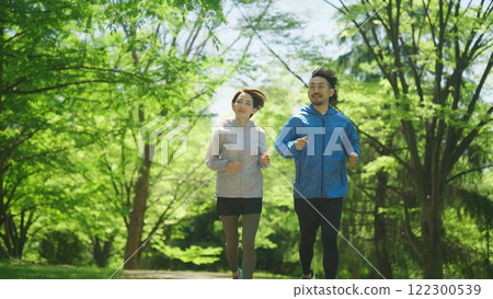 Men and women jogging early in the summer Men and women jogging early in the summer 122300539