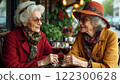 Two elderly women drinking wine in a caf 122300628