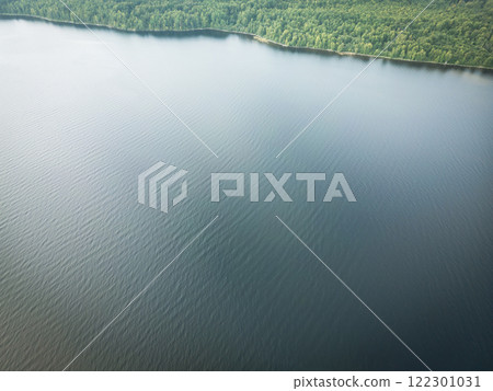 Aerial view forest and lake. View from above. Aerial top view lakeshore. View green forest from above. Aerial view forest and lake. View from above. Aerial top view lakeshore. View green forest from above. 122301031