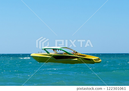 Blue sea and a speedboat floating on the sea. Speed boat is in the blue sea. 122301061