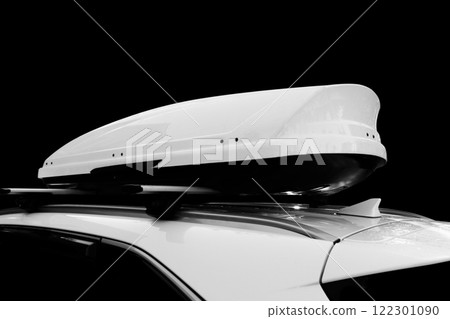 Carrier car roof box isolated. White plastic car rooftop cargo box or roof carrier for traveling. Removable storage container mounted on car roof rack. 122301090