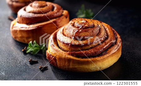 Swedish cinnamon buns or rolls. Freshly baked buns on a black stone table 122301555