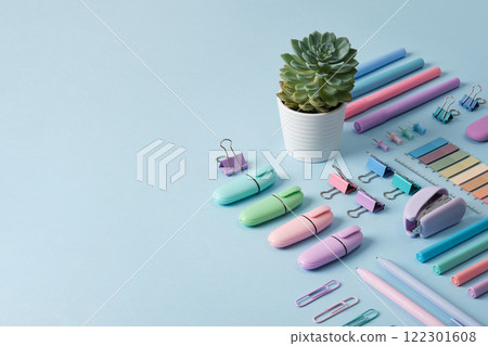 Stationery banner with pastel colored office supplies neatly laid out on light blue background. Place for your text. 122301608