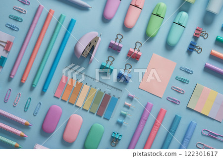 Stationery background with pastel-colored office supplies neatly arranged on a light blue background. Workplace organization. Back to school concept. 122301617