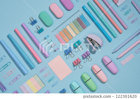 Stationery background with pastel-colored office supplies neatly arranged on a light blue background. Workplace organization. Back to school concept. Stationery background with pastel-colored office supplies neatly arranged on a light blue background. Workplace organization. Back to school concept. 122301620