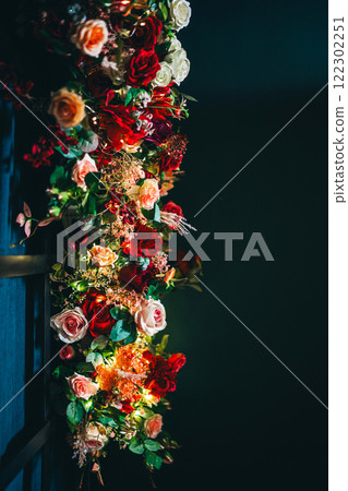 artificial flowers attached to a black lattice. photo zone decoration with flowers artificial flowers attached to a black lattice. photo zone decoration with flowers 122302251