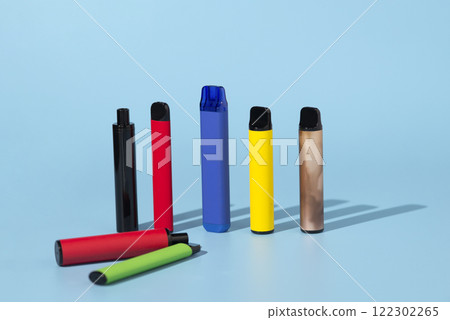 Set of colorful disposable electronic cigarettes on a blue background. The concept of modern smoking 122302265