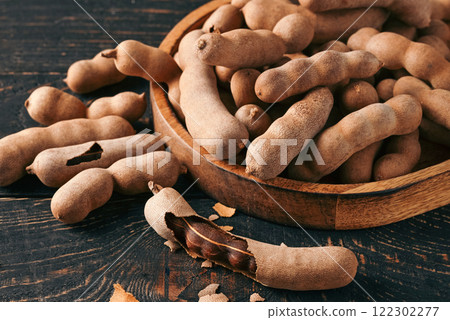 Pile of fresh tamarind fruits in shell close up Pile of fresh tamarind fruits in shell close up 122302277