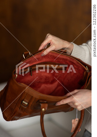 photo of a orange leather bag with retro look. indoors photo 122302286
