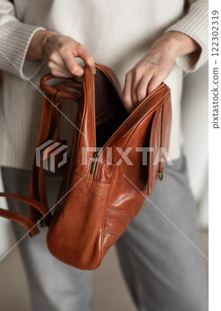 photo of a orange leather backpack with retro look. indoors photo 122302319