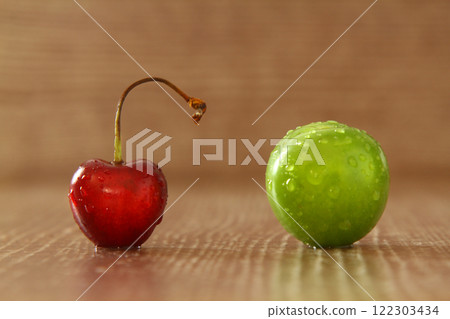 Single whole fresh green Can Erik plum and cherry close up isolated on dark background 122303434