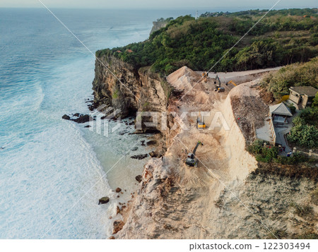 Bulldozers digging on the cliff in Uluwatu, Bali. Drone view 122303494