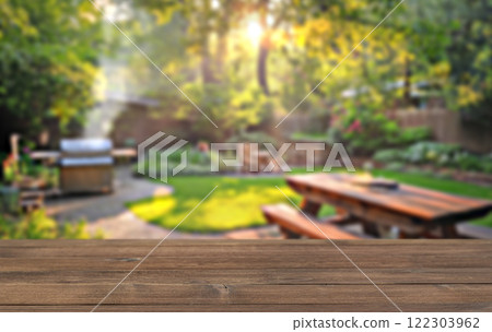 summer time party in backyard garden with grill BBQ, wooden table, blurred background 122303962