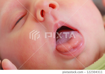 Closeup of newborn baby face, mouth open Closeup of newborn baby face, mouth open 122304311