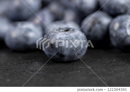 a pile of blueberries scattered on the board a pile of blueberries scattered on the board 122304391