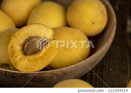 ripe soft apricot fruits on the cutting board 122304414
