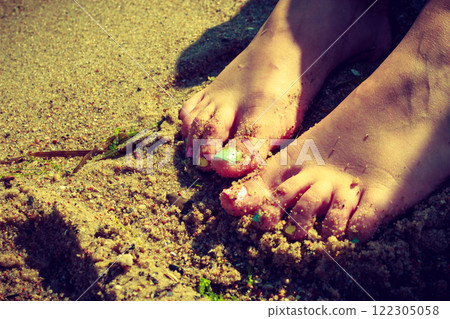 Woman feet with nail polish on sand 122305058