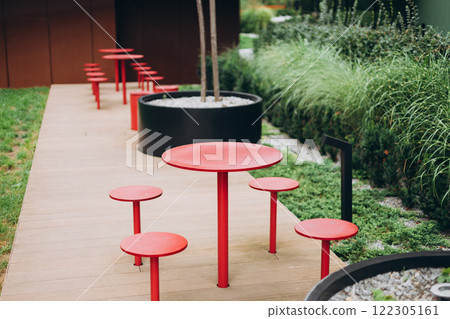 Outdoor street cafe red tables ready for service. Modern Empty cafe terrace with table and chair, morning time. Food concept. 122305161